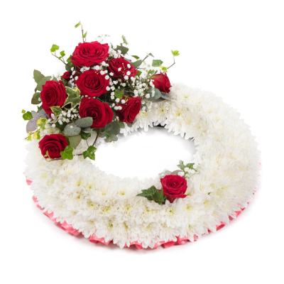 Wreath SYM-314 - This white massed wreath is finished with a red rose spray for an extra special tribute.